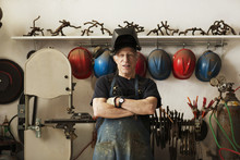 Portrait Of Senior Man With Arms Crossed Standing In Workshop