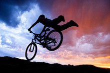 Silhouette Of Mountain Biker In Jump