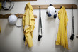 © Cavan Images - Protective workwear hanging from coat hooks
