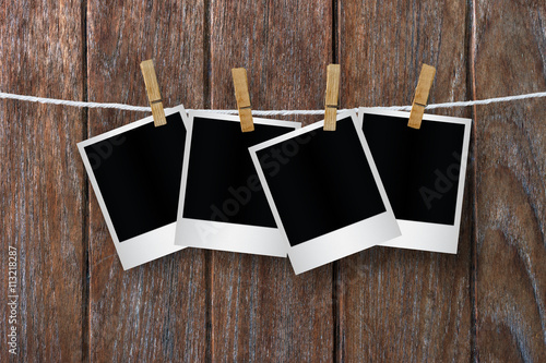 Fotografie, Obraz Clothespin hanging with blank polaroid photo papers.