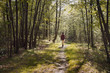 © Cavan Images - Woman walking in forest