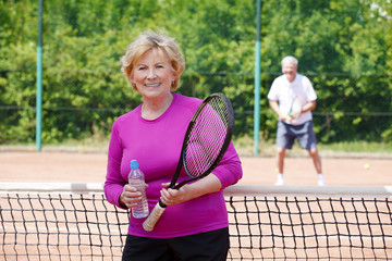 Active senior woman playing tennis