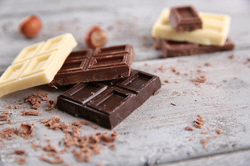 Mix of chocolate with nuts on wooden table