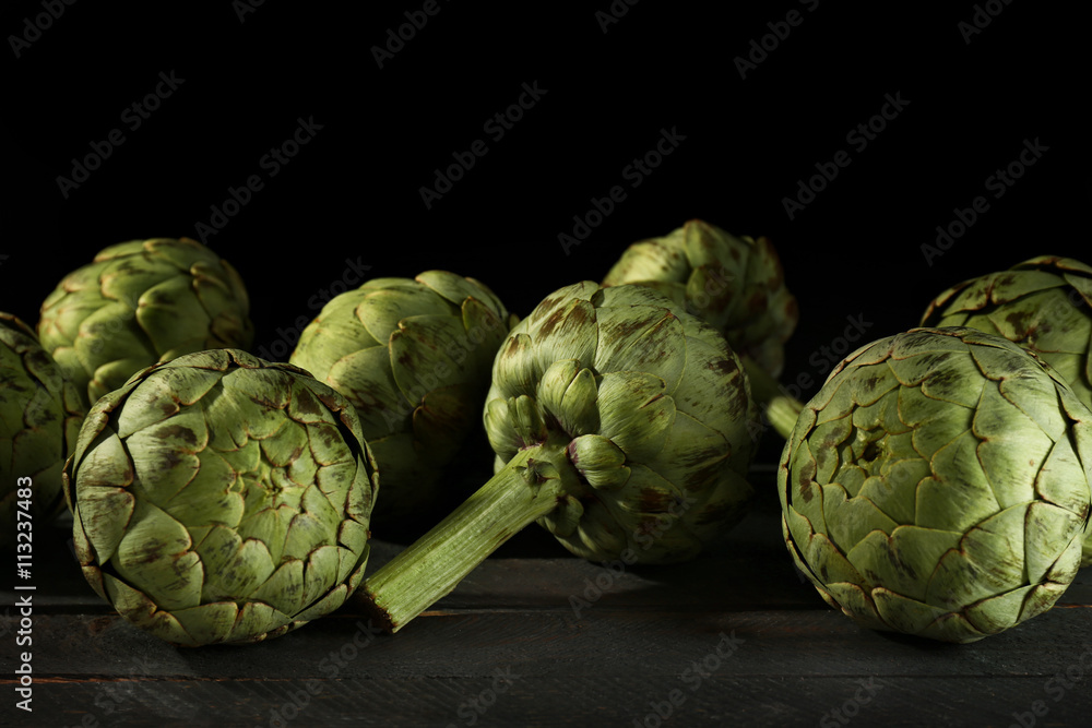 Artichokes on wooden table