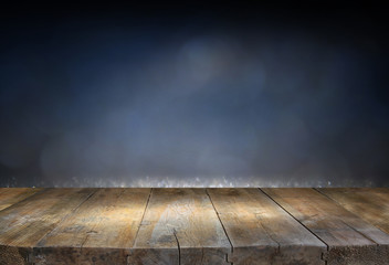image of wooden table in front of glitter lights background