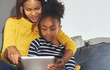 © Flamingo Images - Black mom and daughter learning on tablet