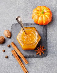 Wall Mural - Pumpkin confiture, jam, sauce with spices on stone table Top view