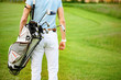 Golfer walking with golf bags