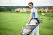 © Yakobchuk Olena - Golfer walking with golf bags