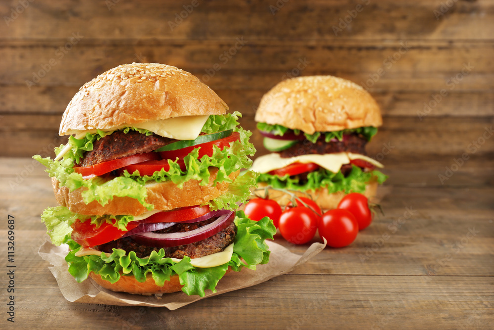 Double hamburgers on wooden background