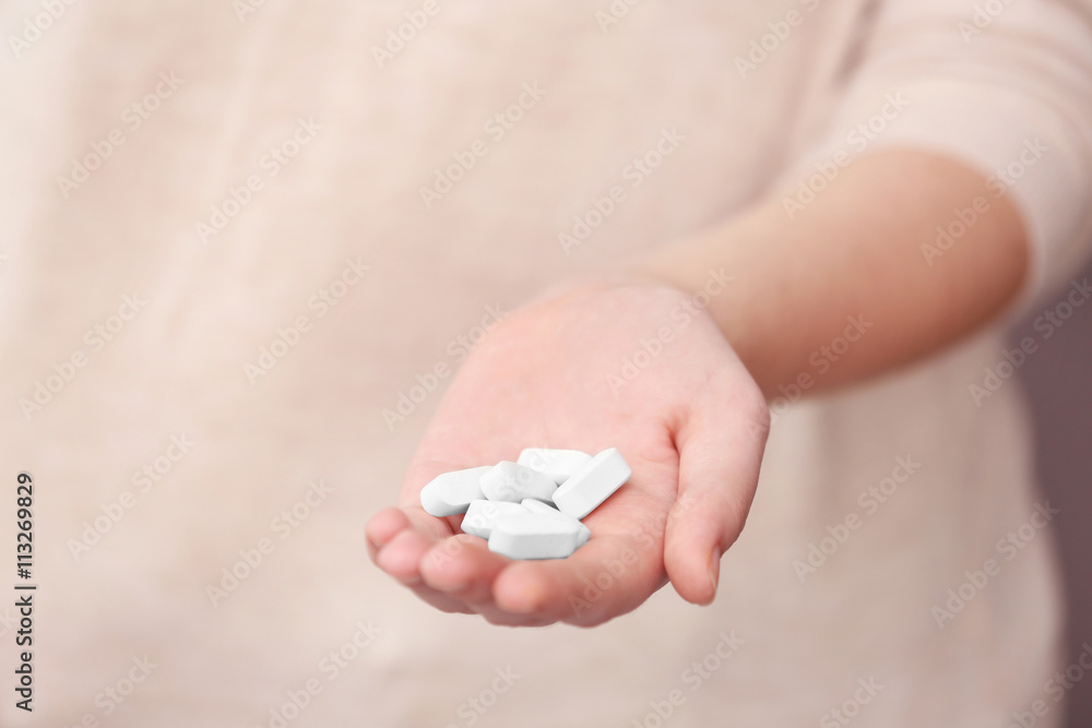 Woman taking vitamins, closeup