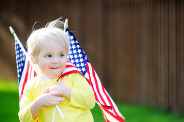 Wall Mural - Cute toddler boy holding american flag