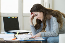 Worried Woman Suffering Stress Doing Domestic Accounting Paperwork Bills And Invoices