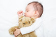 © DN6 - Baby sleeping with her teddy bear, new family and love concept (