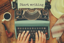 Man Typing On Vintage Typewriter With Text: START WRITING