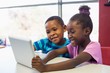 © WavebreakMediaMicro - School african american kids using a digital tablet in classroom