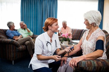 Wall Mural - nurse taking care of pensioner
