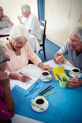 Group of seniors drawing and interacting