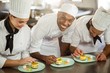 © WavebreakMediaMicro - Chefs team finishing dessert plates