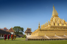 Group Of Buddhist Monks Walking Around That Luang Stupa, Landmark Of Vientiane, Lao PDR