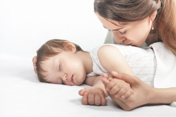 Wall Mural - Mother kissing a baby. Care concept