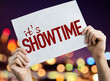 Its Showtime placard with night lights on background