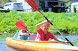 Two boys kayaking on the river. Active happy friends, teenage schoolboys, having fun together enjoying adventurous experience with kayak on a sunny day during summer vacation