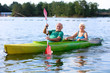© cromary - Senior couple kayaking on the river. Healthy elders enjoying summer day outdoors. Sportive people having fun at the nature. Active retirement concept.