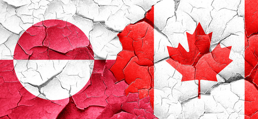 greenland flag with Canada flag on a grunge cracked wall