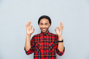 Sticker - Cheerful attractive african young man showing ok sign