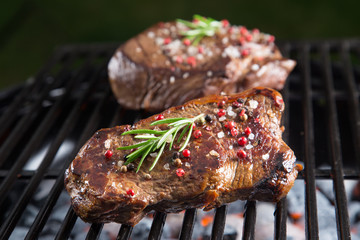 Grilled beef steak on the grill.