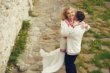 Wall Mural - Groom whirls a bride in a white dress with red poppy