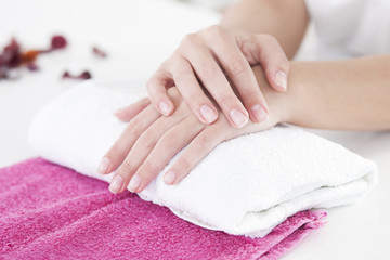 Beautiful woman hands on a towel in manicure salon