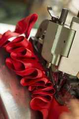 Wall Mural - Red cloth stitched and ruffled through a sewing machine