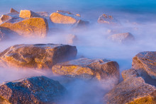 Sea Rocks In Haze At Sunset