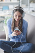 © stokkete - Girl listening to music with her smartphone