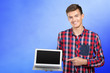 © fotofabrika - Young handsome businessman holding laptop