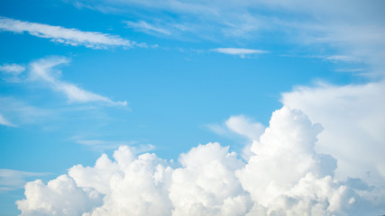 Wall Mural - fantastic soft white clouds against blue sky with copy space for background design