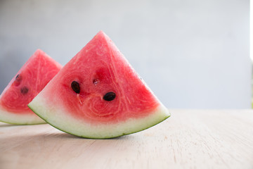 Wall Mural - Slices of watermelon on wooden desk background