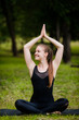 © romankosolapov - Woman in meditation pose Yoga on the green grass