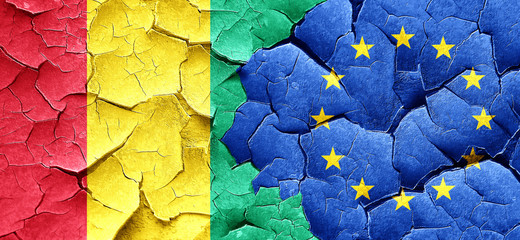 Guinea flag with european union flag on a grunge cracked wall