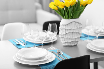 Wall Mural - Table served with dishes and a bouquet of tulips