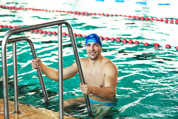 Wall Mural - Handsome sporty man in the swimming pool