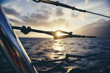Close-up Of Railing In Boat Against Sea During Sunset
