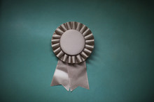 Close-up Of Award Ribbon Against Green Background