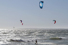 Rear View Of Man Kitesurfing On Sea Against Sky
