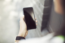 Cropped Image Of Woman Holding Smartphone