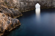 © Cavan Images - High angle view of natural arch over calm sea