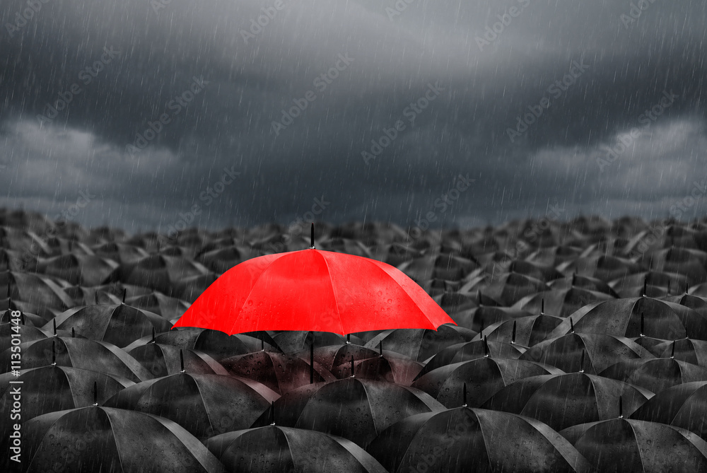 red umbrella in mass of black umbrellas - obrazy, fototapety, plakaty 