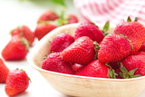Fototapeta Miasta - Ripe red strawberries on wooden table